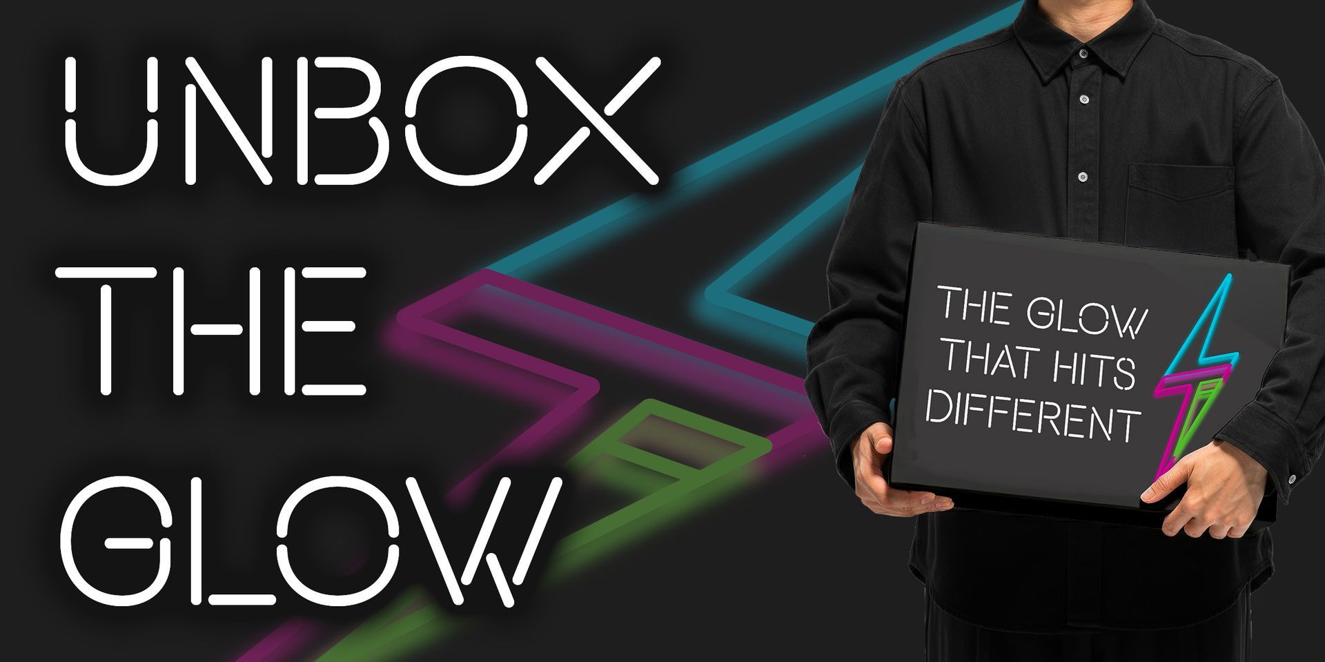 A man holds  packaging featuring branded box with neon lightning bolt logo and bold typography.
