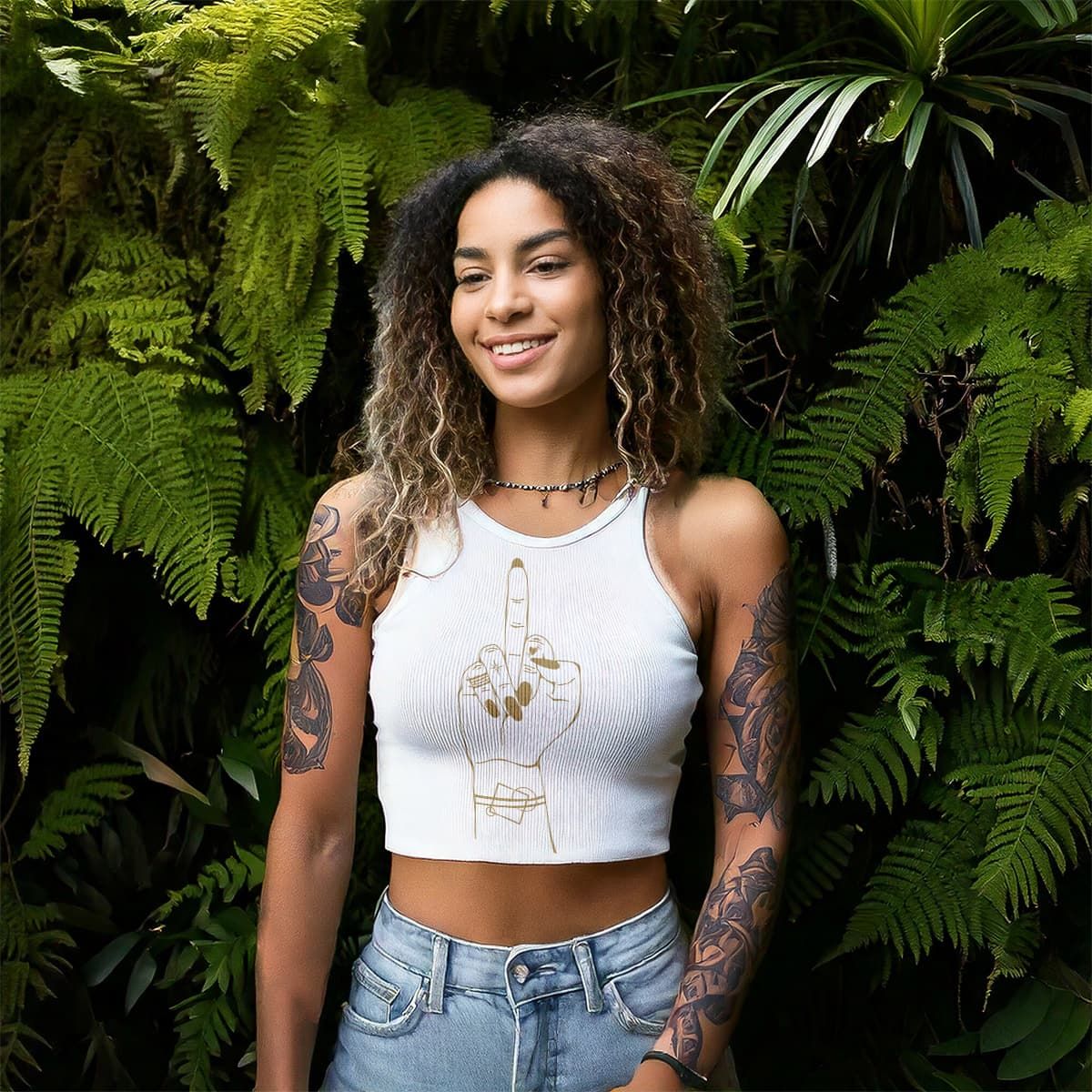 A Woman stands in a forest wearing a white tshirt with acustom illustrated middle finger logo design on it