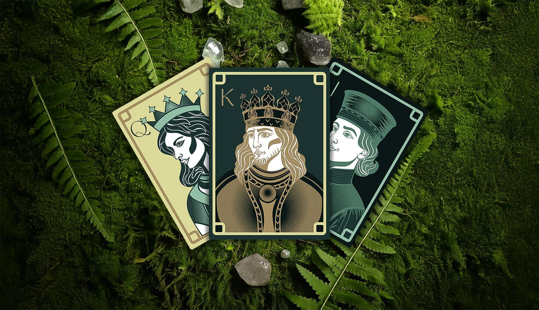 Custom illustrated playing cards sitting on a bed of moss