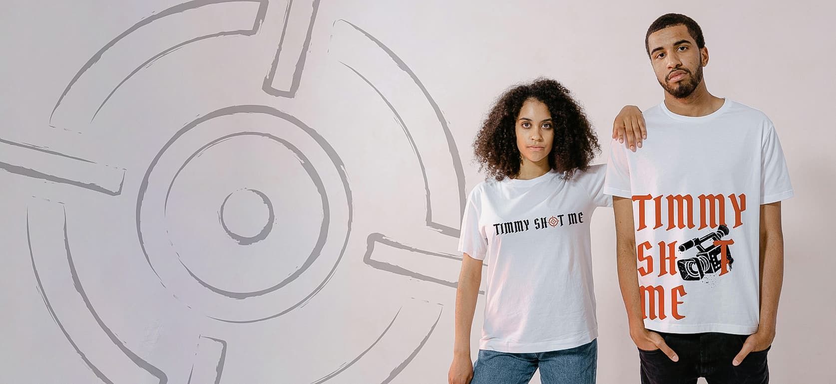 a man and woman stand wearing Timmy shot me branded merch apparel.