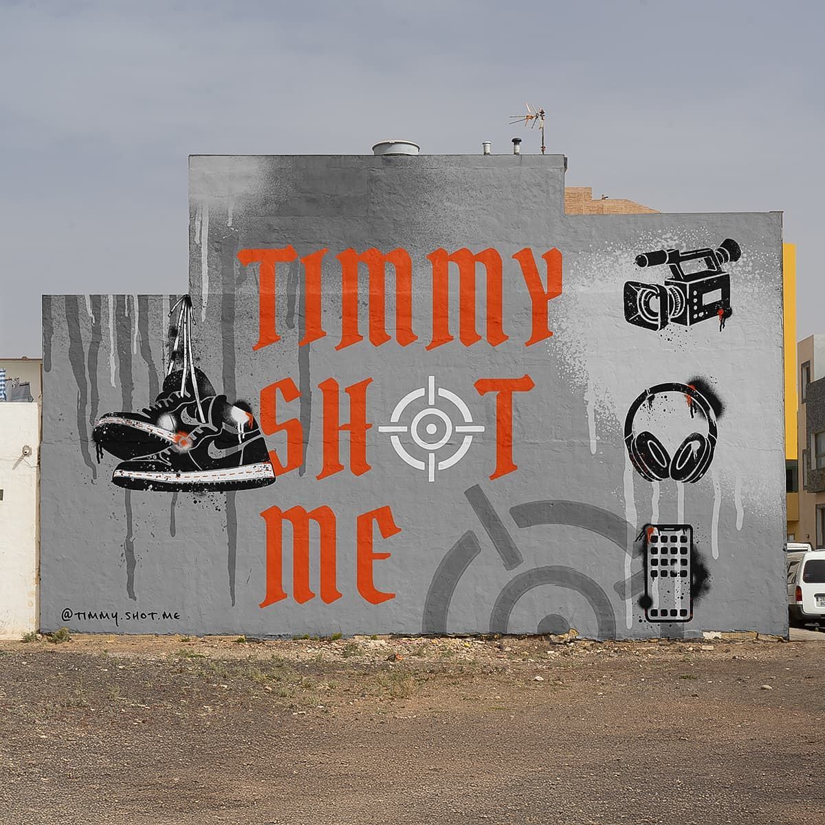 The side wall of a building spray painted with timmy shot me logo and brand assets