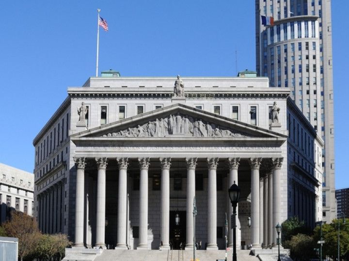 a large building with columns and a flag on top