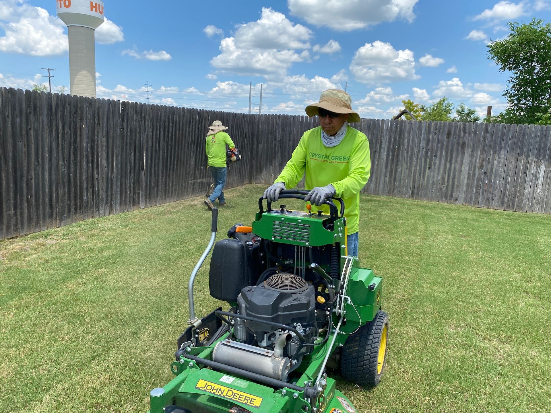 a man is riding a lawn mower on a lush green lawn .