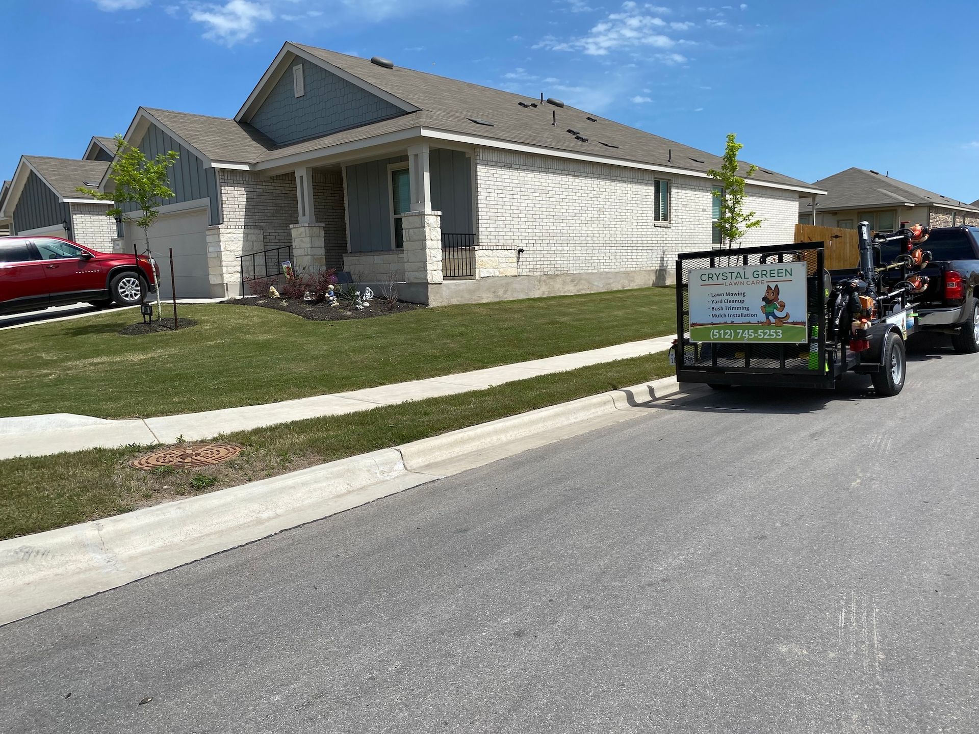 a man is driving a golf cart down a street in front of a house .