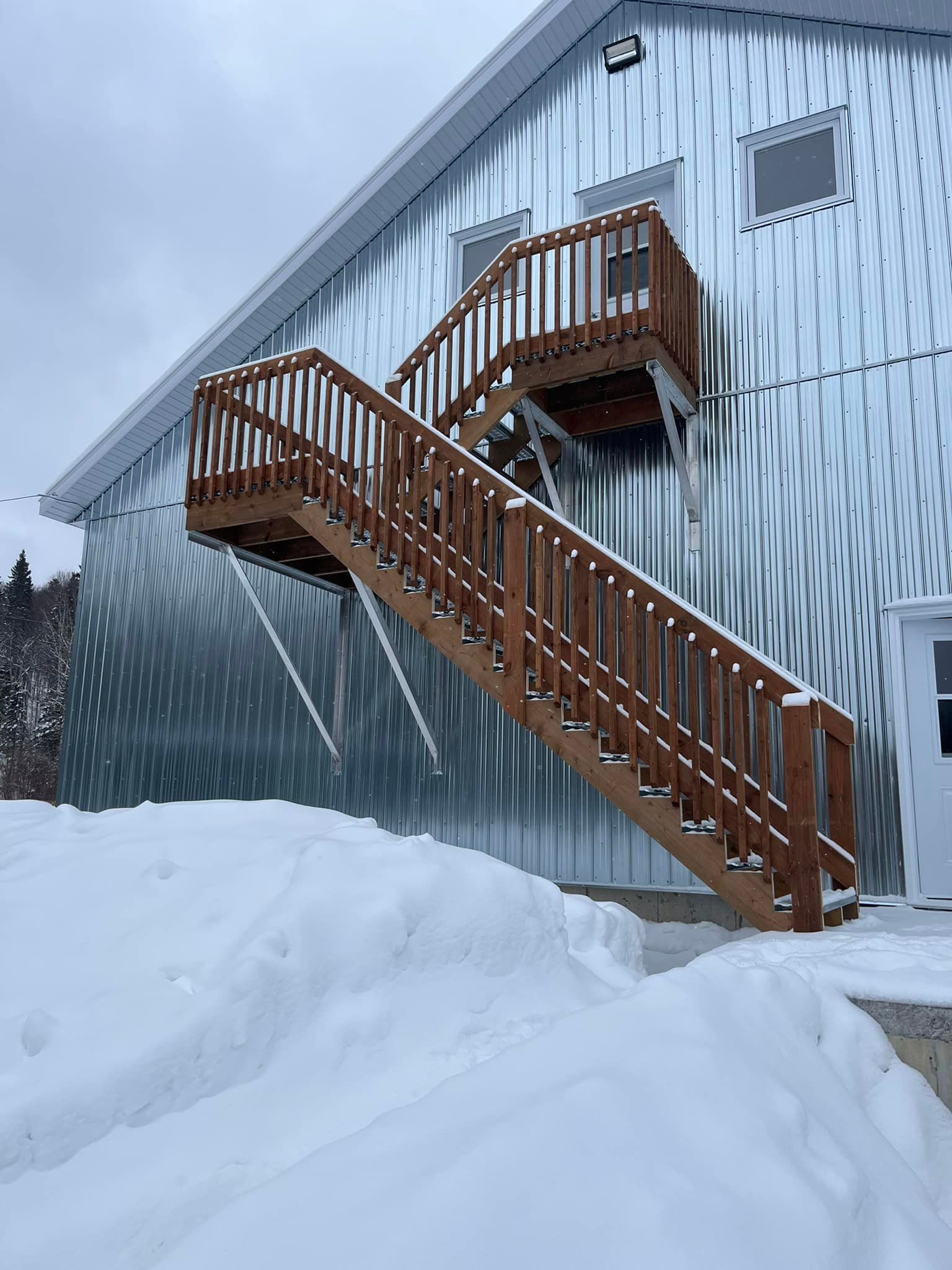 Un escalier en bois menant à un balcon sur le côté d'un bâtiment.