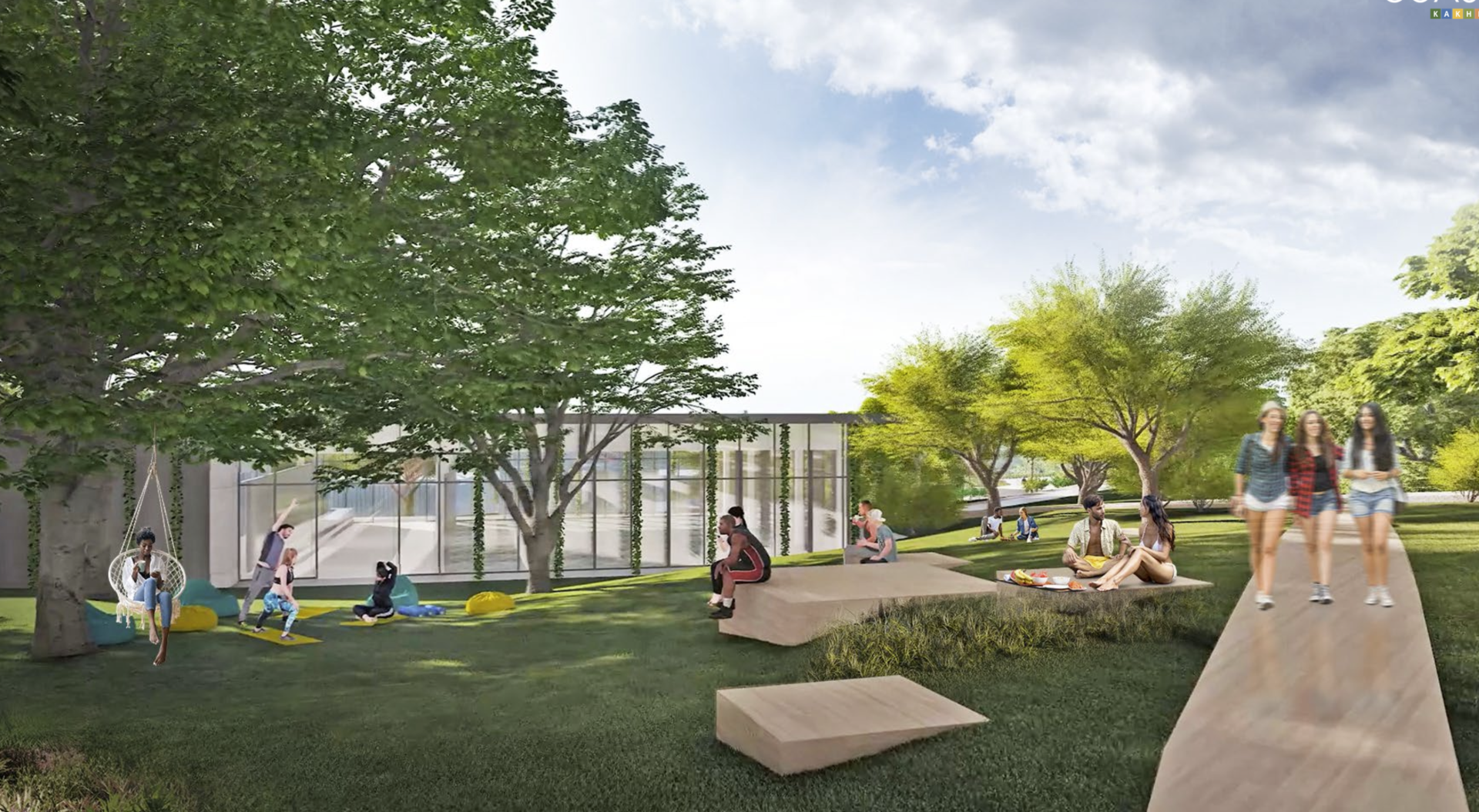 People relaxing in a park-like setting with trees, a modern building, and a stone walkway.