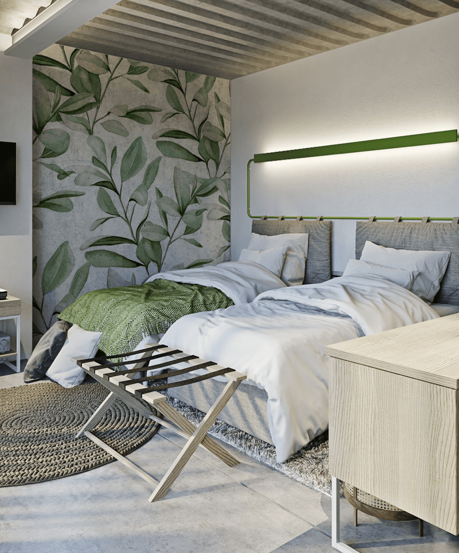 Two beds in a modern room with botanical wallpaper and a luggage rack.