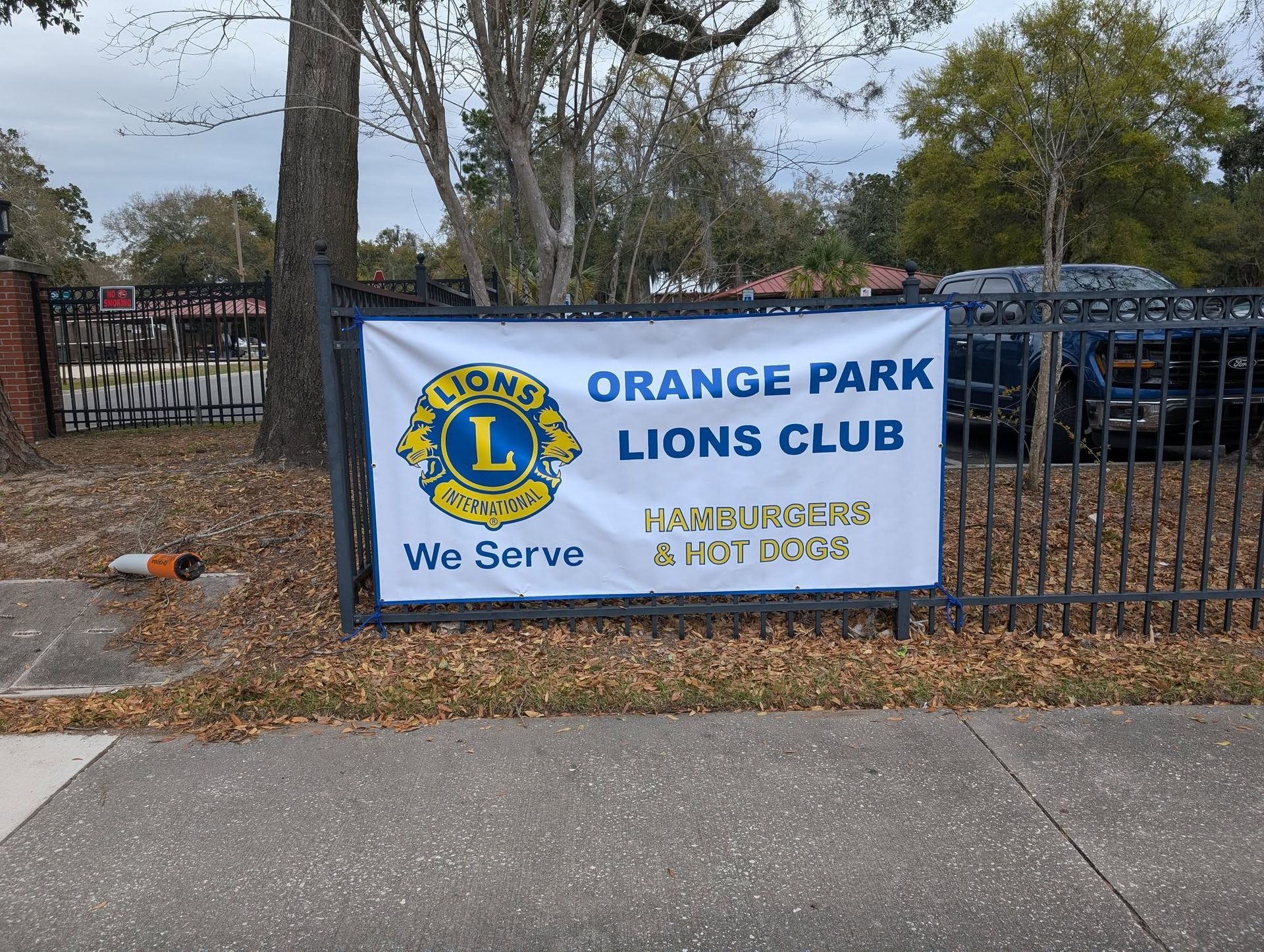 A sign that says orange park lions club on it