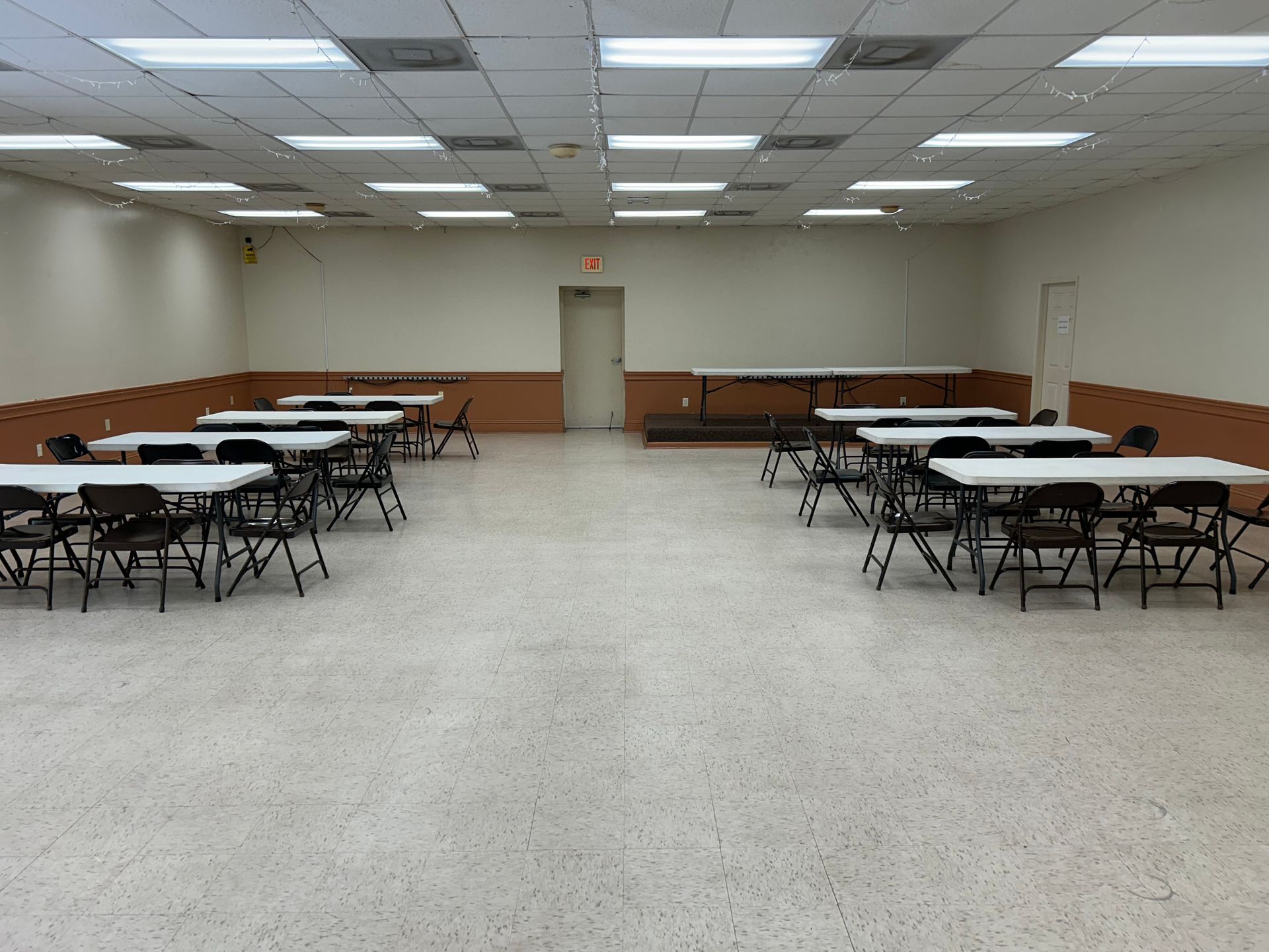 A large empty room with a flag on the wall.