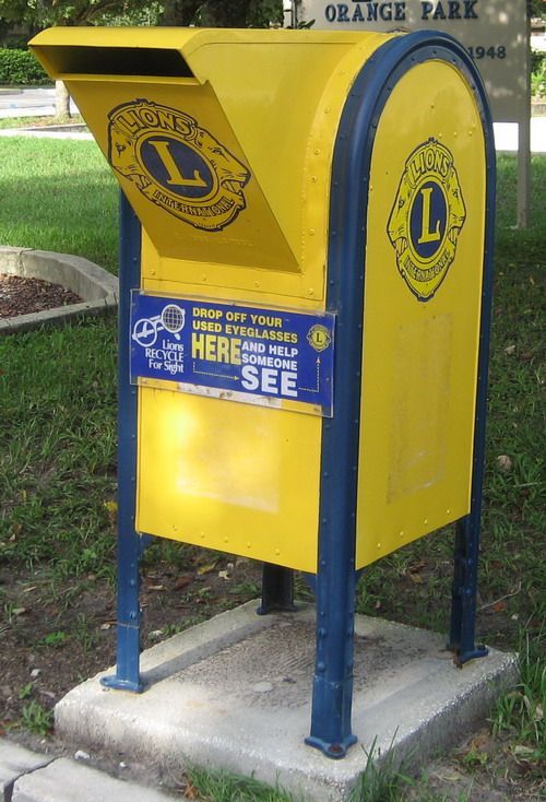 A yellow and blue mailbox that says here to see
