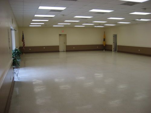 A large empty room with a flag on the wall.