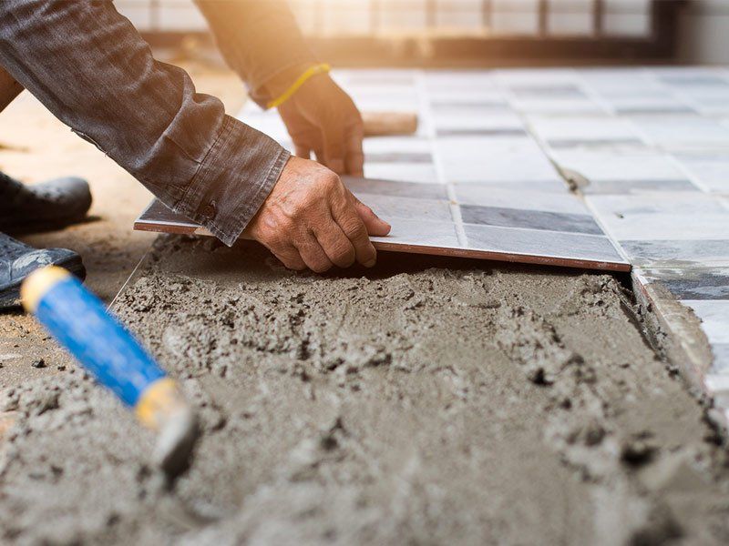 worker laying tiles