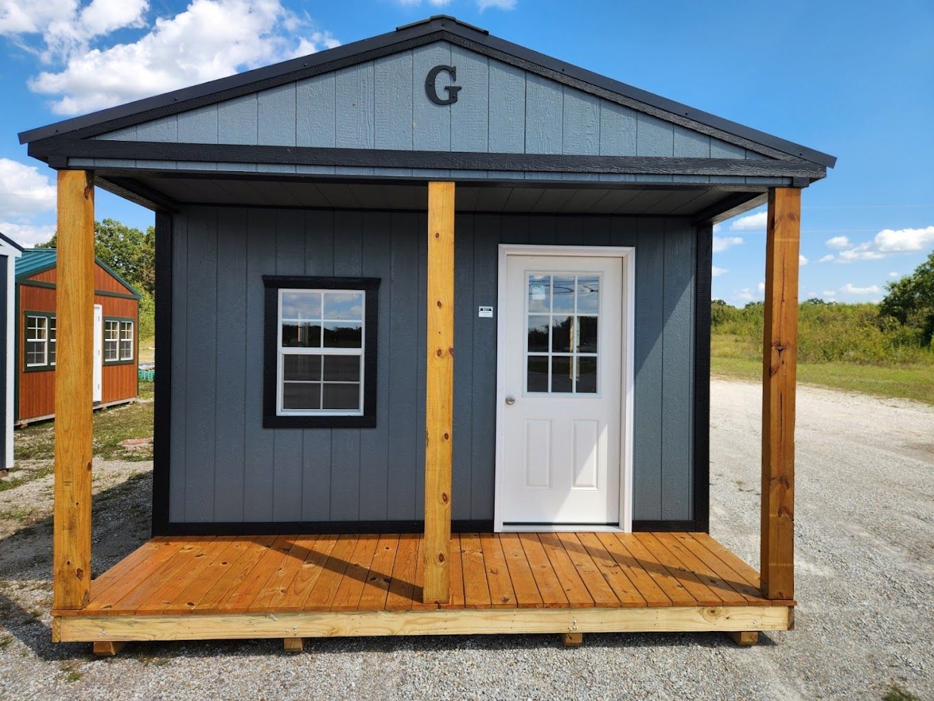 A small shed with a porch and a window.
