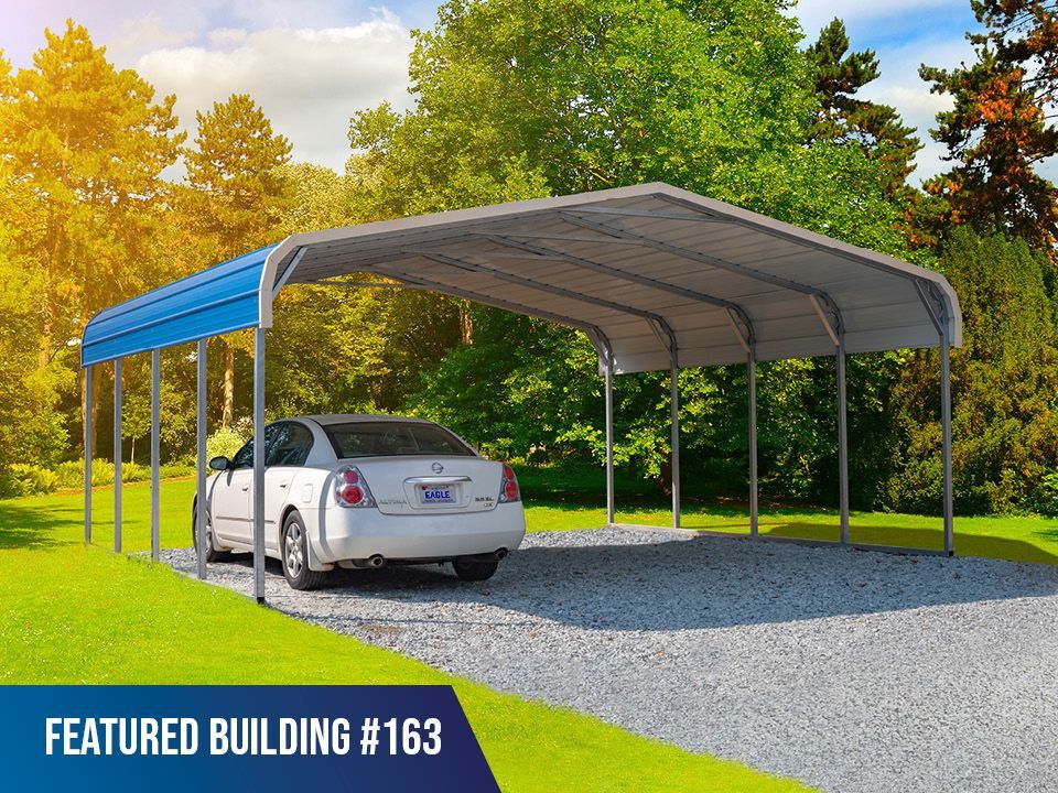 A car is parked under a carport in a driveway.