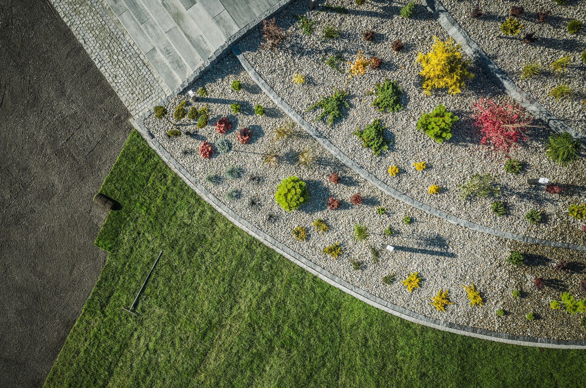 An aerial view of a garden filled with lots of plants and rocks.
