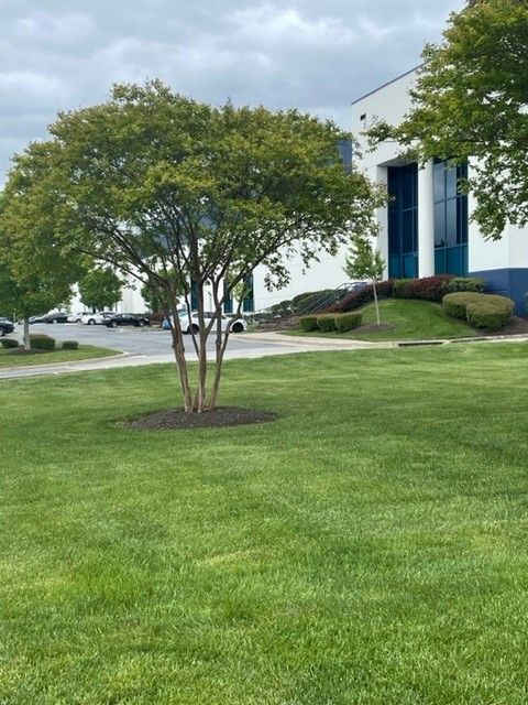 A brick building with a red door and stairs.