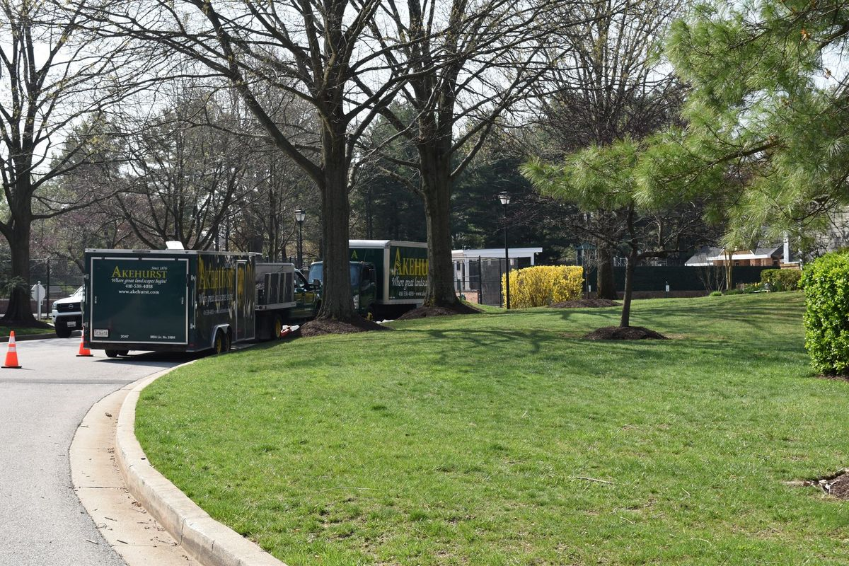 A truck that says ' a & a ' on it is parked on the side of the road