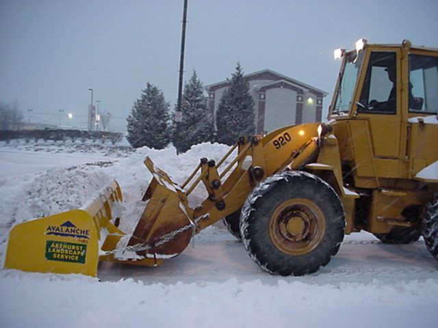 A yellow tractor with the number 920 on it