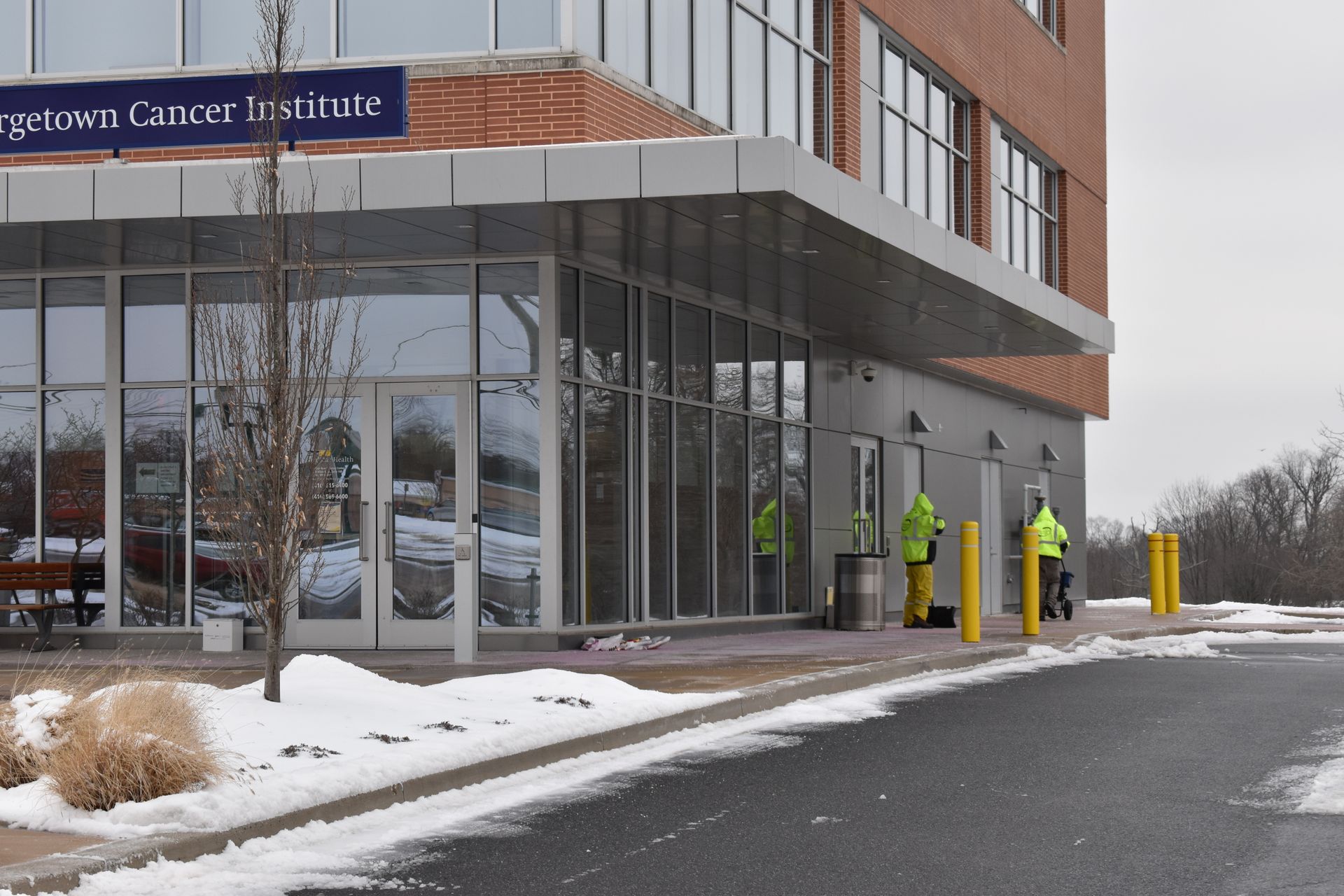 A brick building with a red door and stairs.