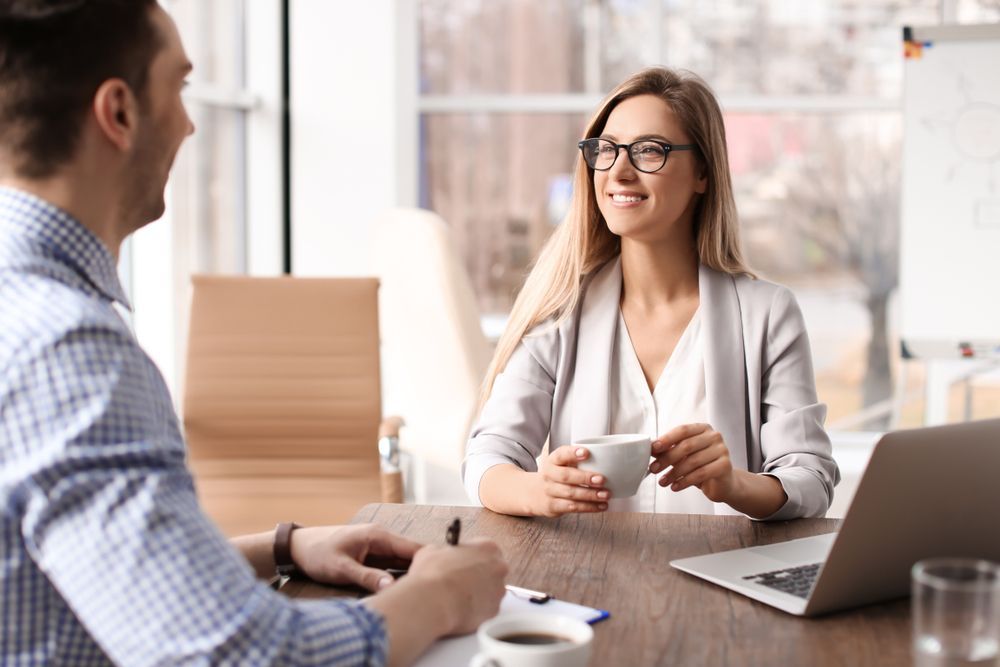 Woman and Man in an Office Setting While Doing an Interview — Search Partners in Melbourne, VIC