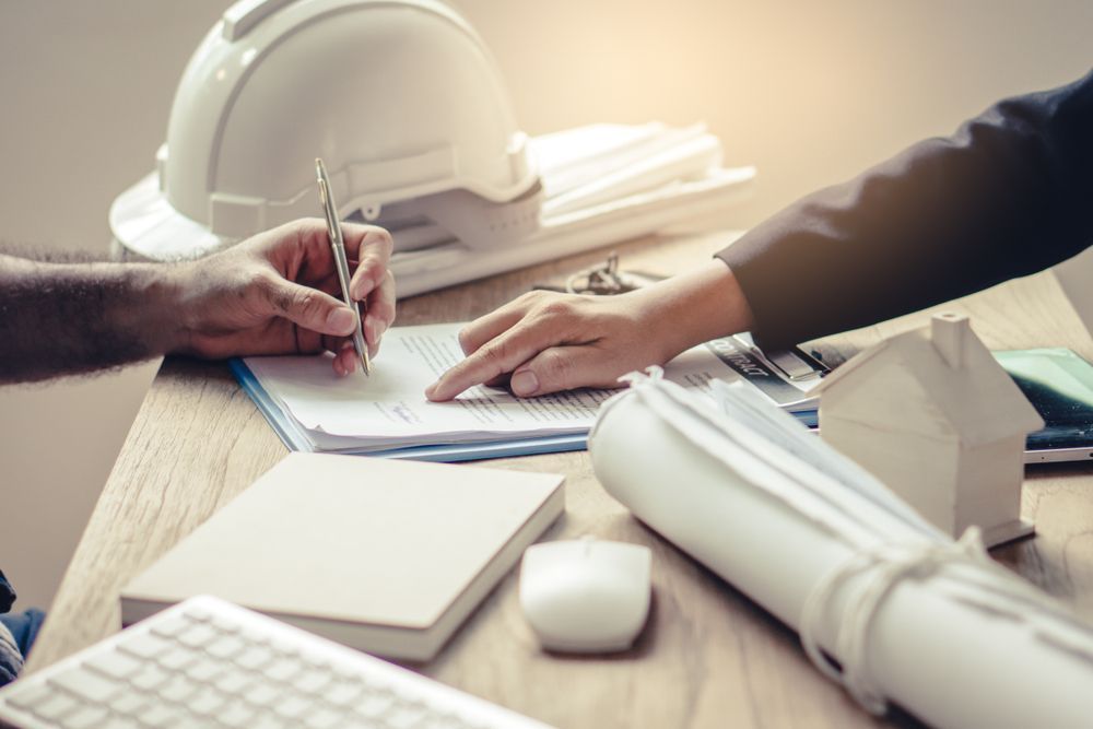 Person Signing a Document, With a Woman Pointing — Search Partners in Melbourne, VIC