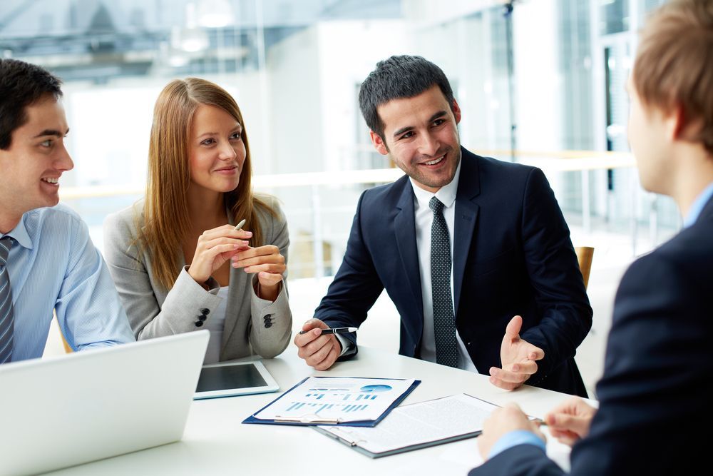 Business People at a Table, in a Meeting, Gesturing and Smiling — Search Partners in Melbourne, VIC