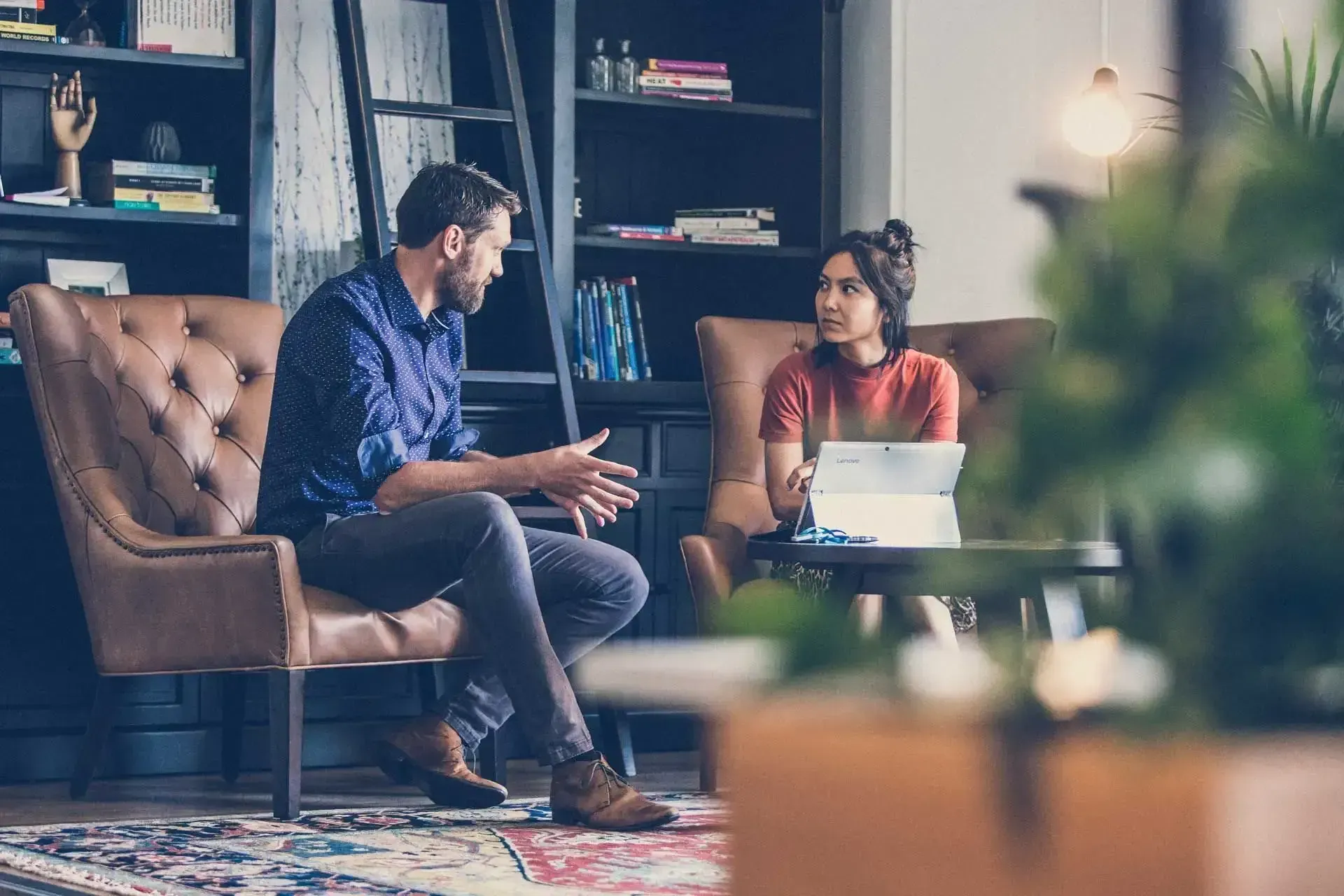 A Man and a Woman Are Sitting on a Couch Talking to Each Other — Search Partners in Melbourne, VIC