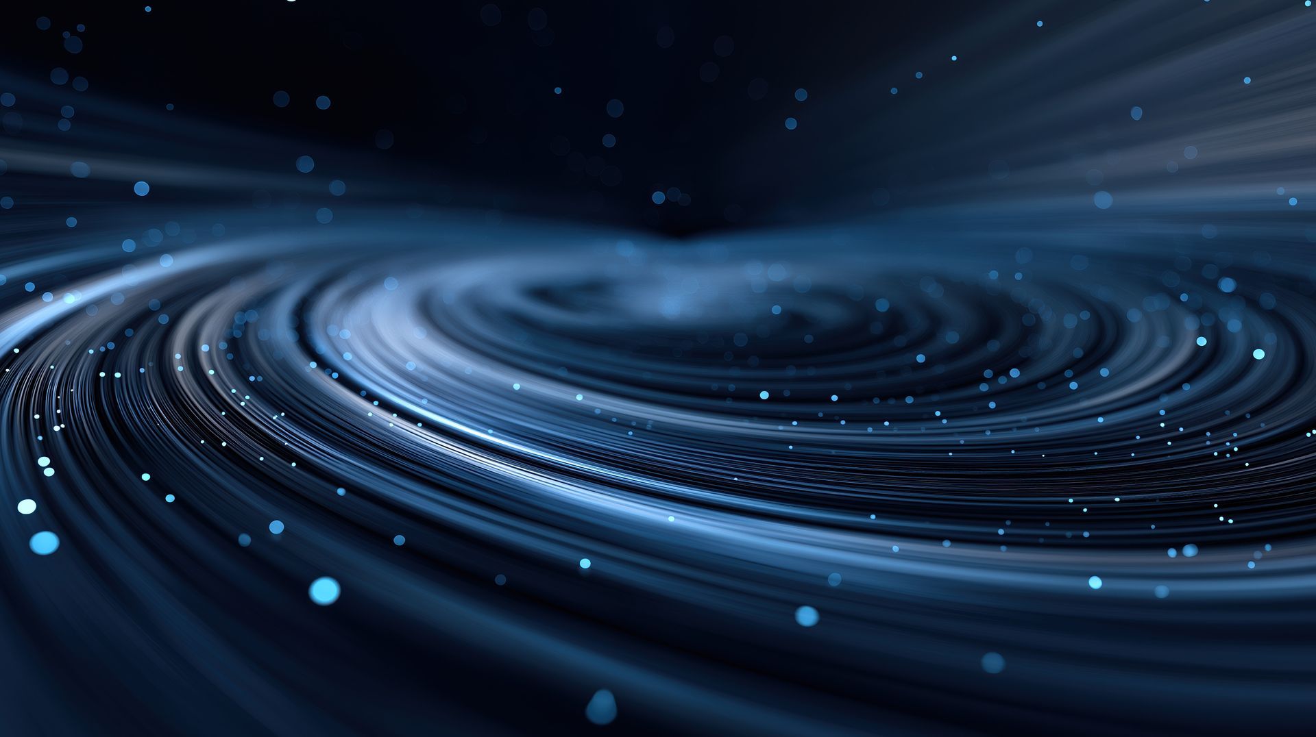 Swirling blue and black abstract design with small, glowing particles.