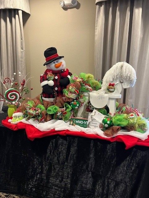 Holiday display with snowman, candy, and decorations on a table with red and white accents.