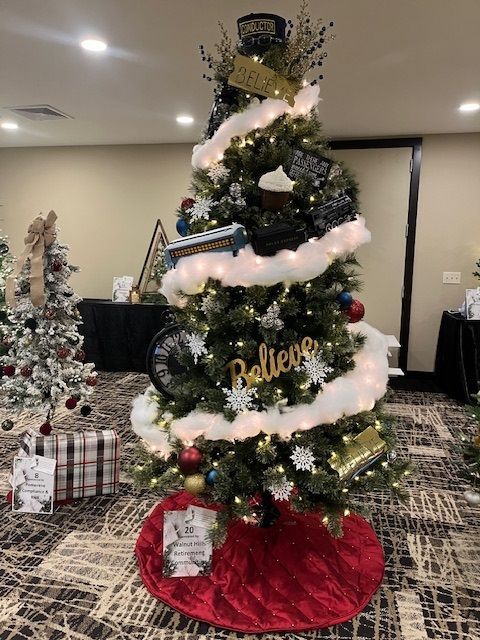 Christmas tree decorated with white fluff, ornaments, and a