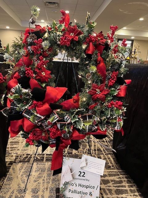 Christmas wreath, red and black, on display for auction; sponsored by Griffin's Hospice.
