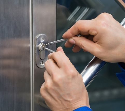 Male Lockpicker Fixing Door Handle At Home