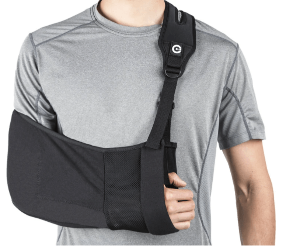 A man wearing a gray shirt and a black arm sling