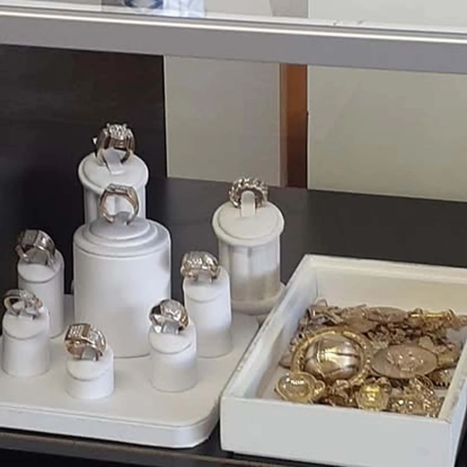 A display of rings and bracelets on a table in a store.