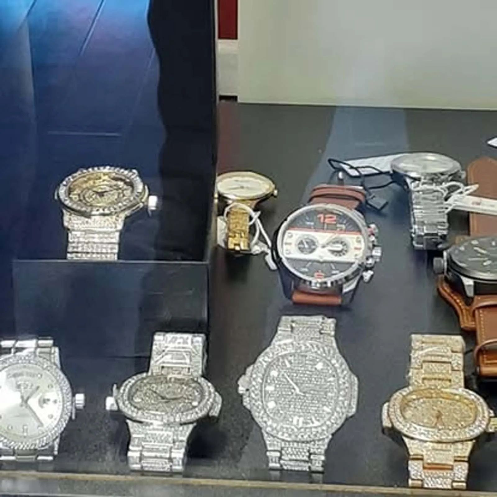 A variety of watches are on display in a store window