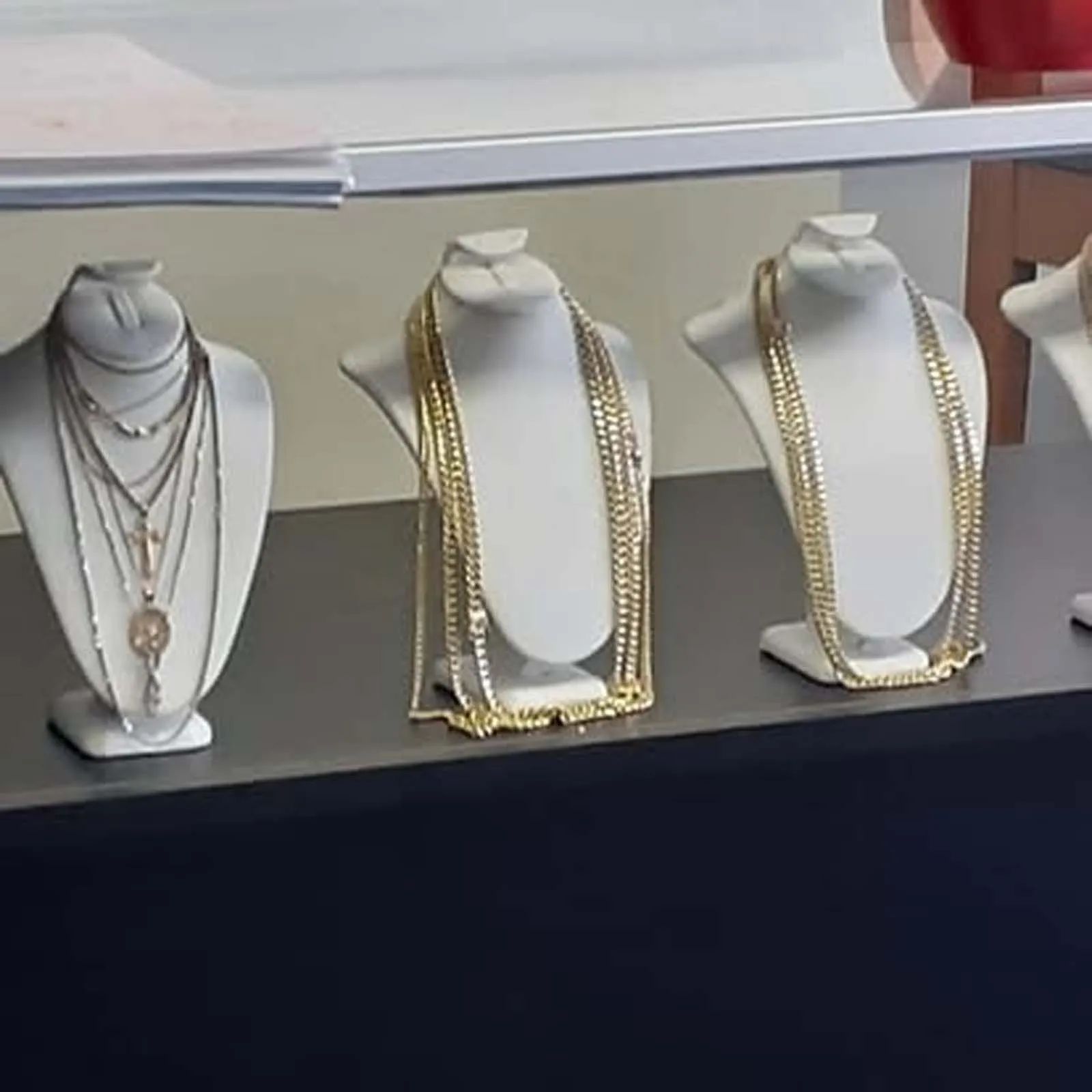 A display of necklaces on mannequins in a store