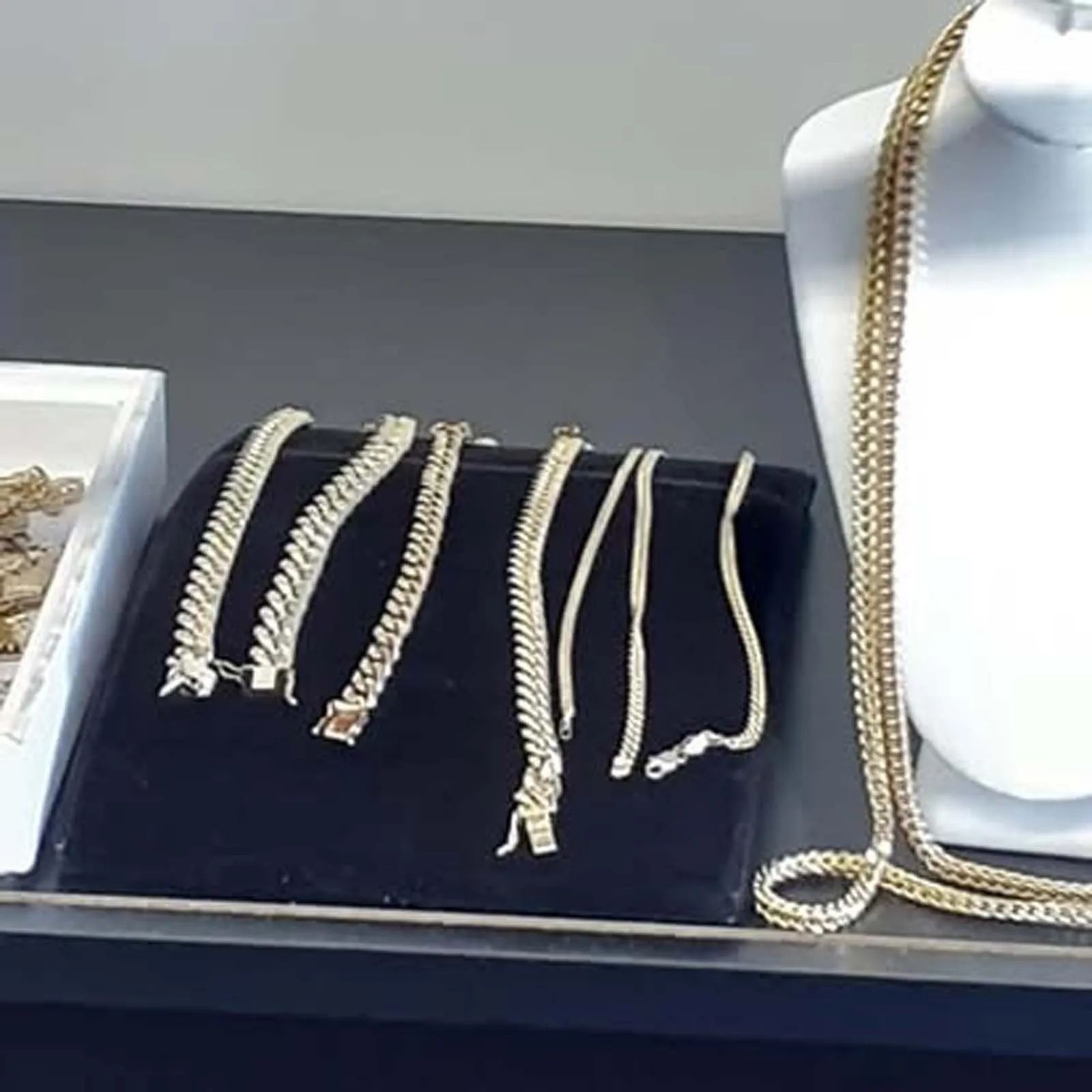 A display of necklaces and bracelets on a mannequin