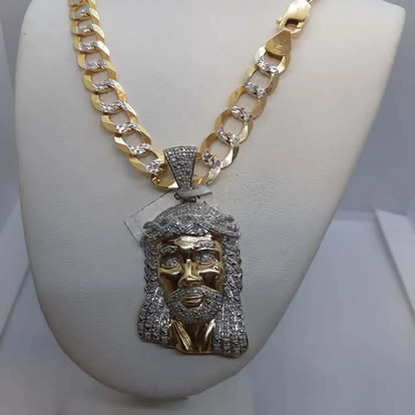 A gold chain with a jesus pendant on it