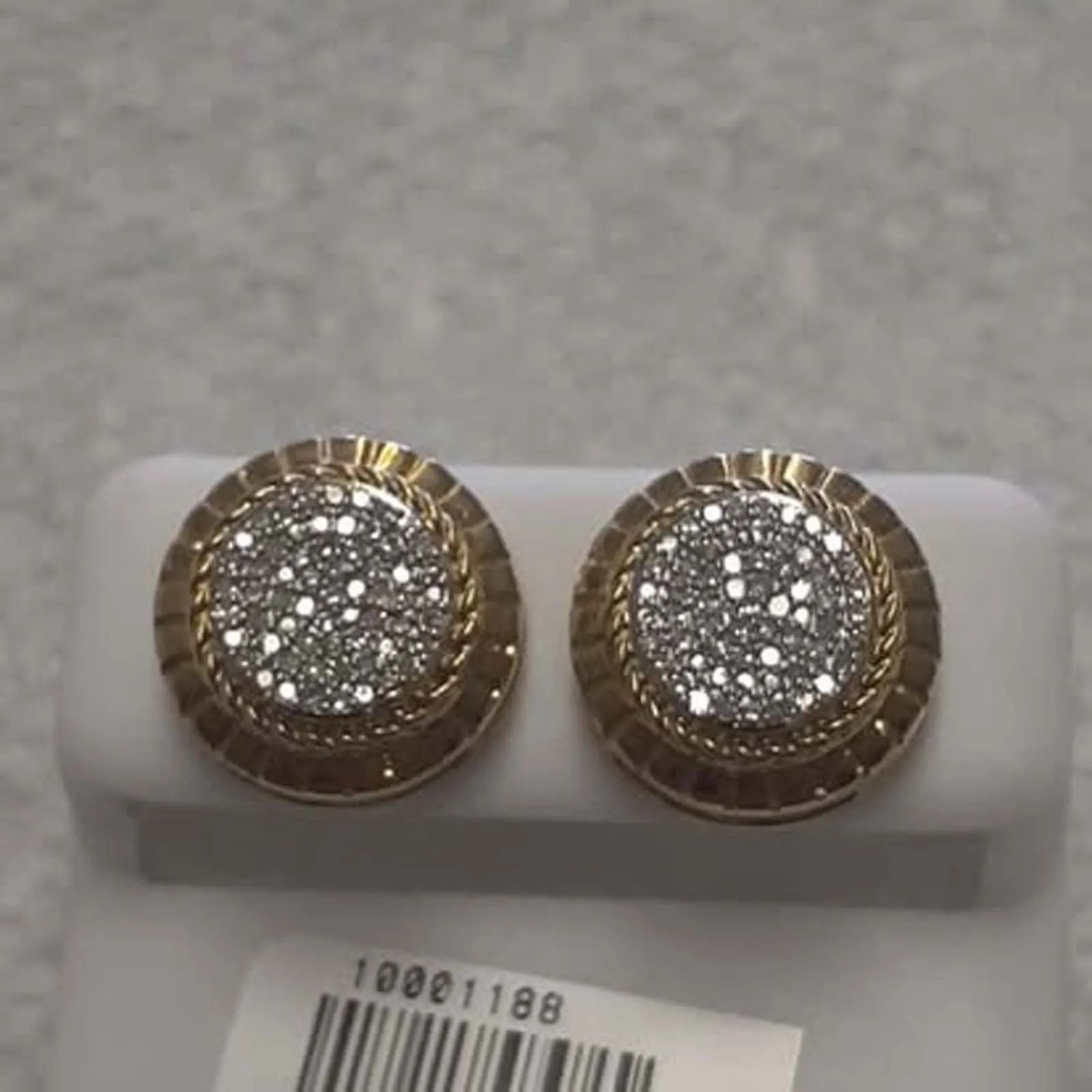 A pair of gold stud earrings with diamonds on them