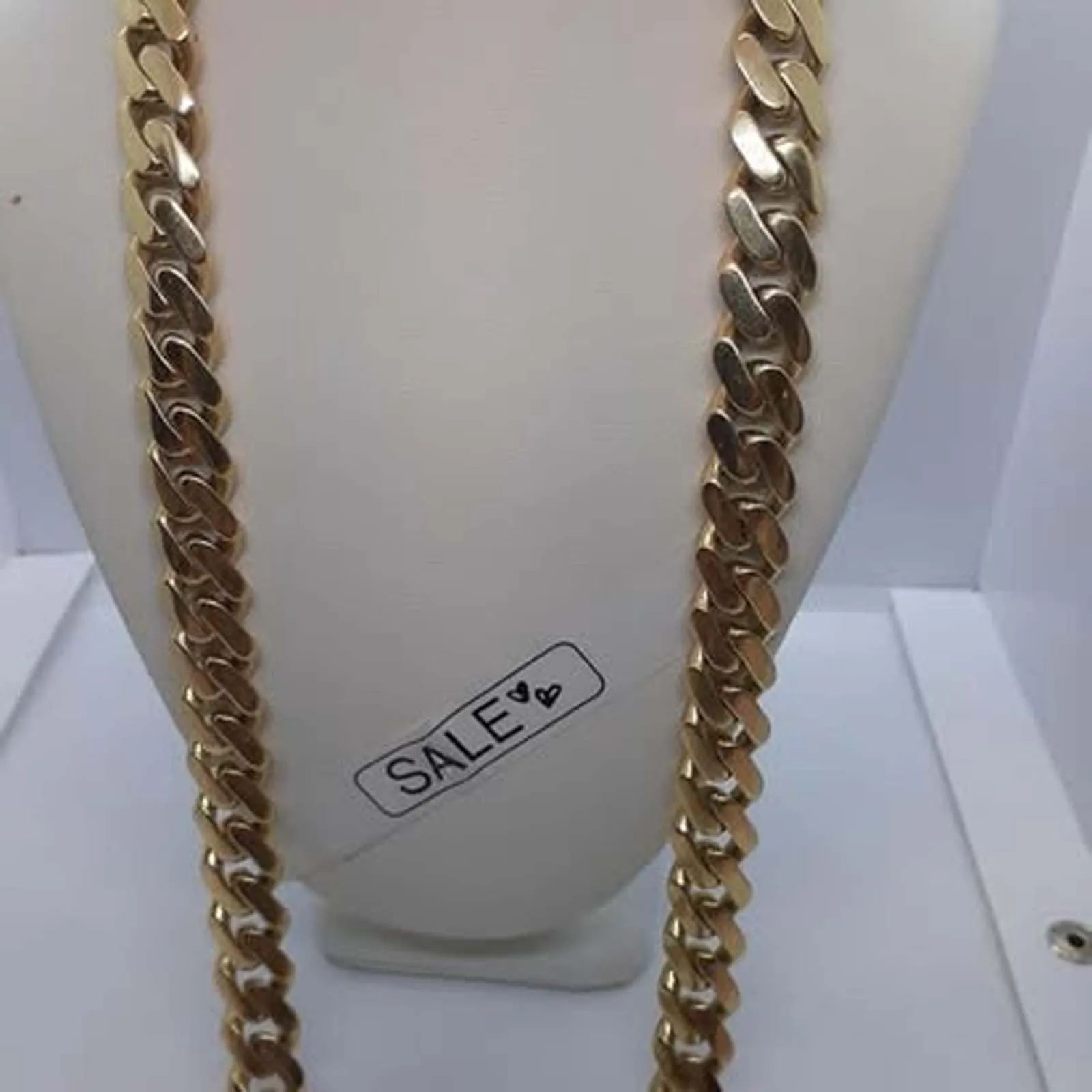 A gold chain with a sale tag on it