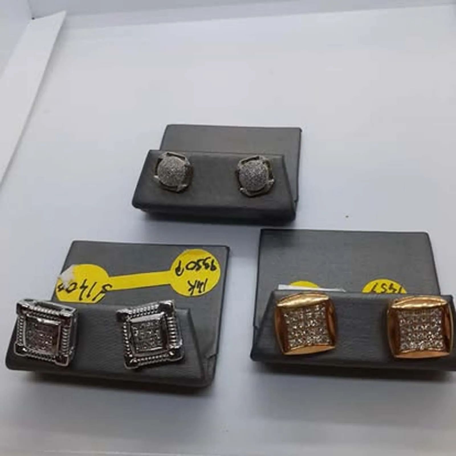 Three pairs of earrings are sitting on top of each other