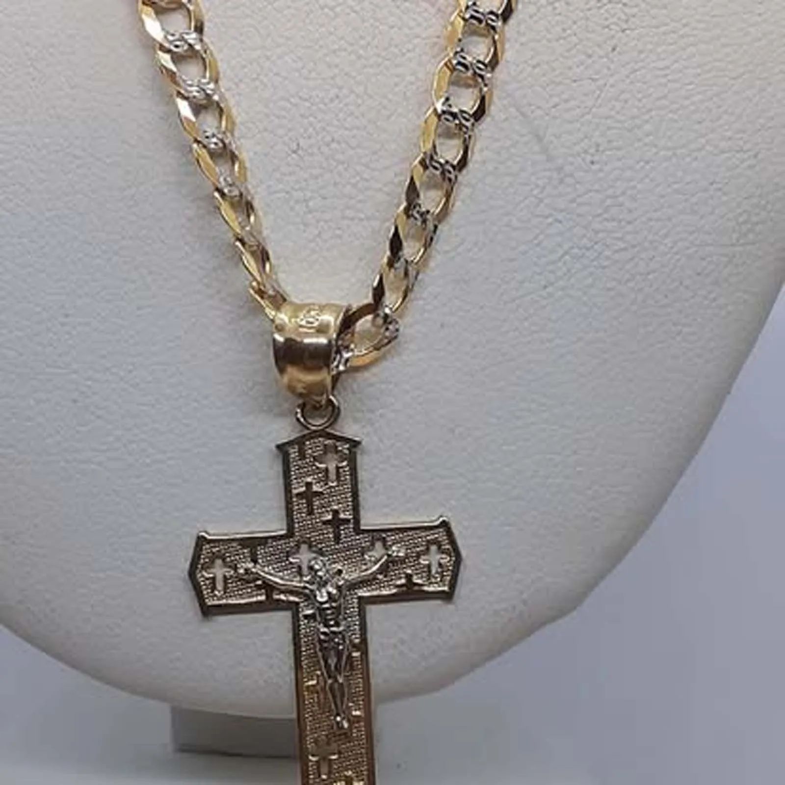 A gold chain with a cross pendant on it