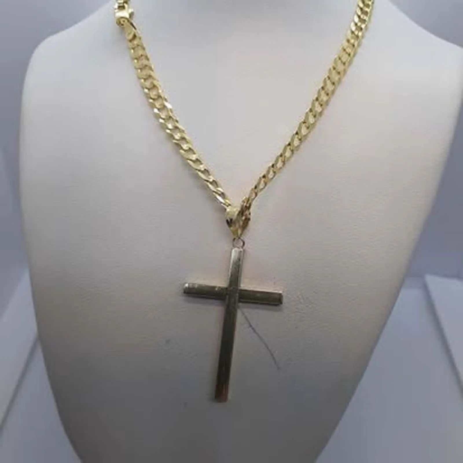 A gold chain with a cross pendant on it