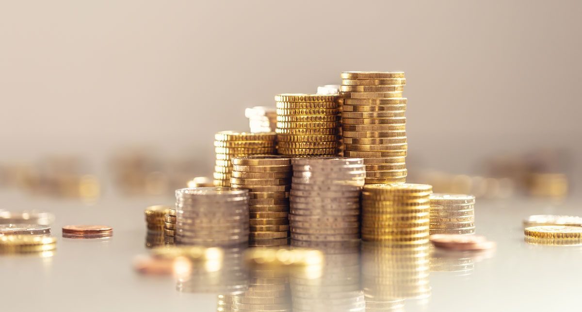 A pile of coins stacked on top of each other on a table.