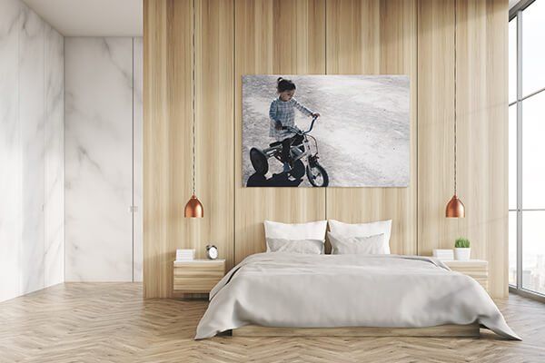 large photo of a girl riding a bike on top of a bed