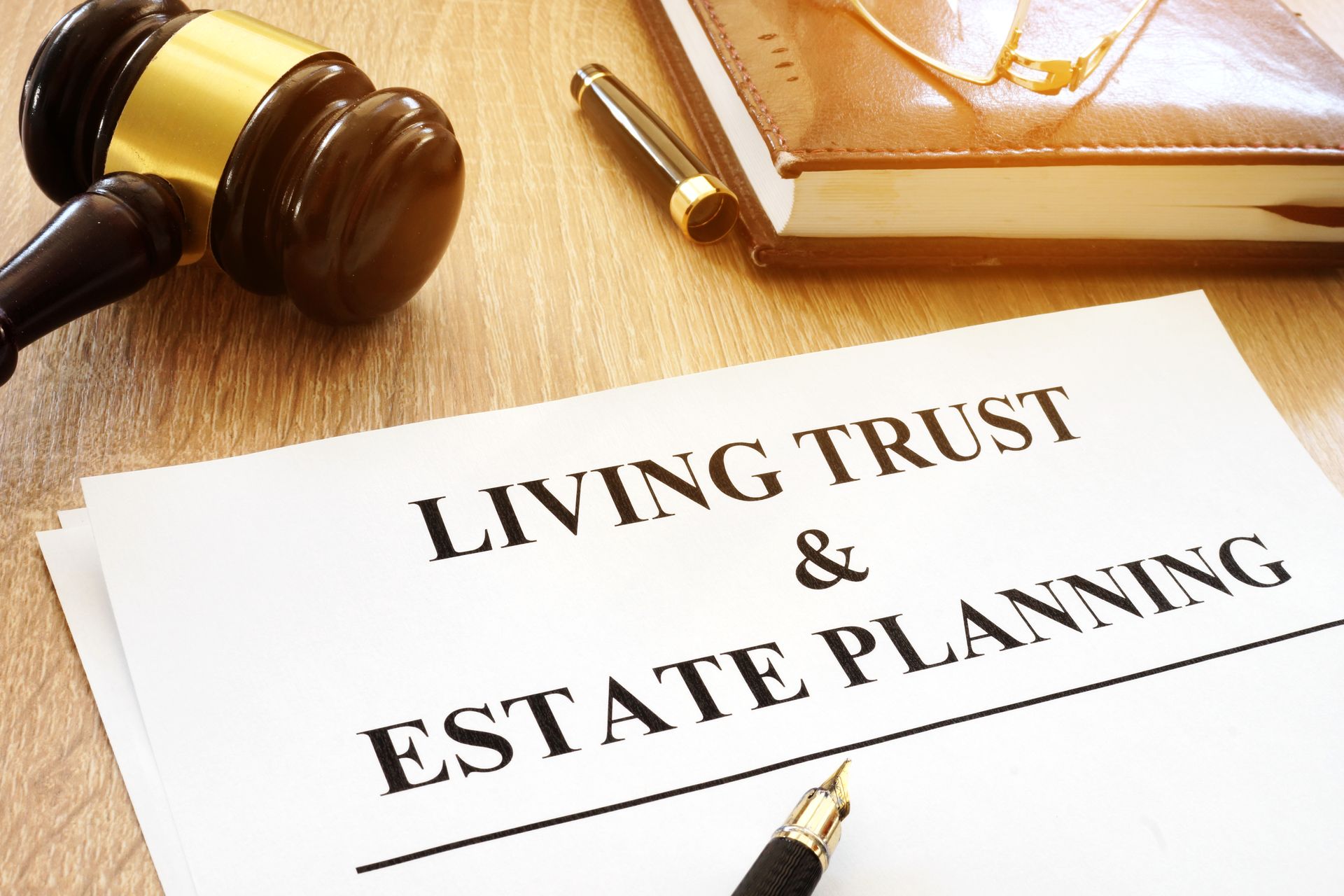 Living Trust & Estate Planning document beside a gavel and pen on a desk