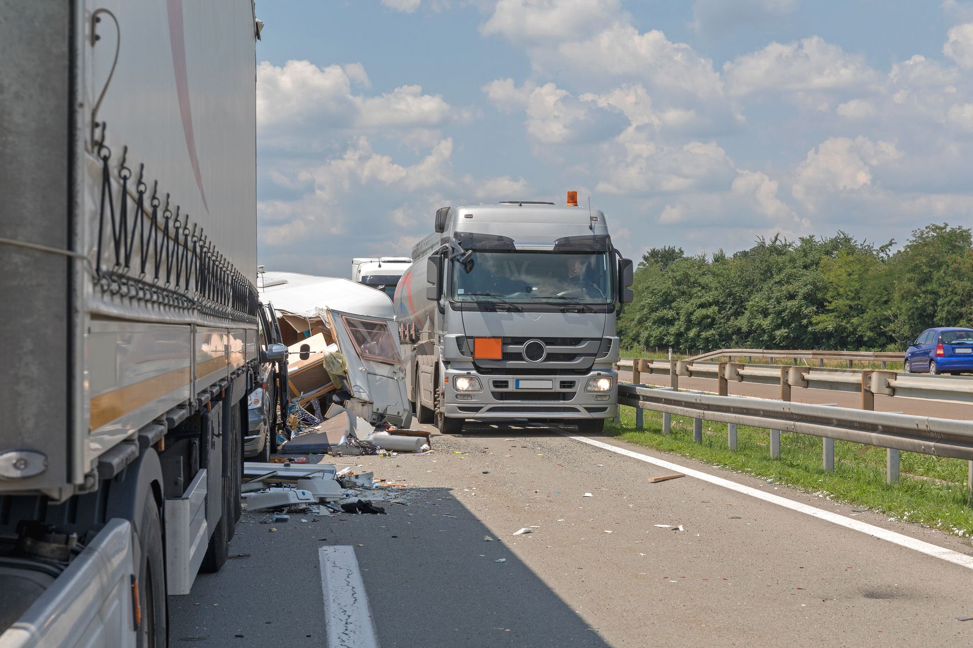 Truck crash on highway with debris and damaged vehicles blocking the lane
