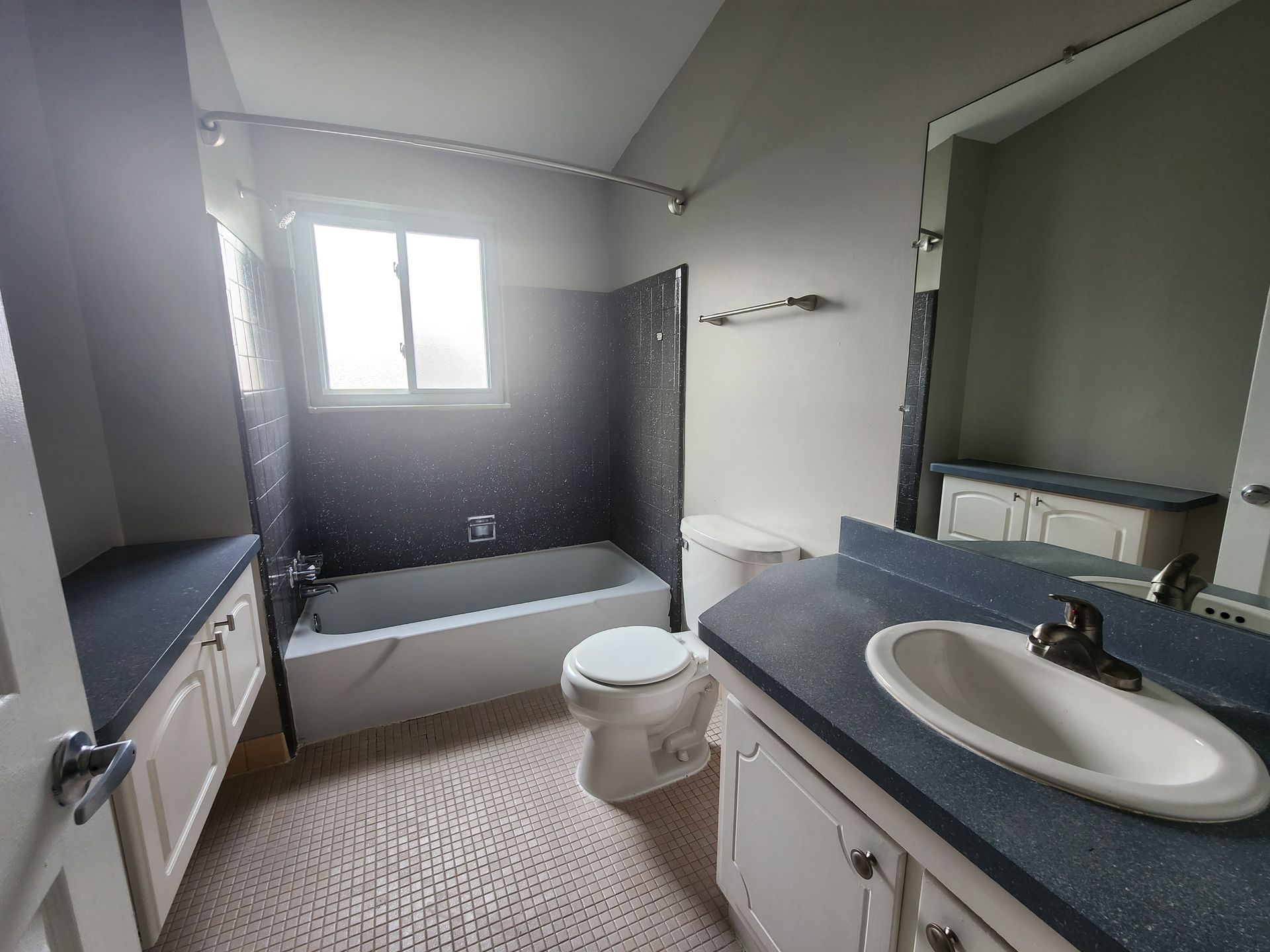 A bathroom with a toilet , sink and bathtub