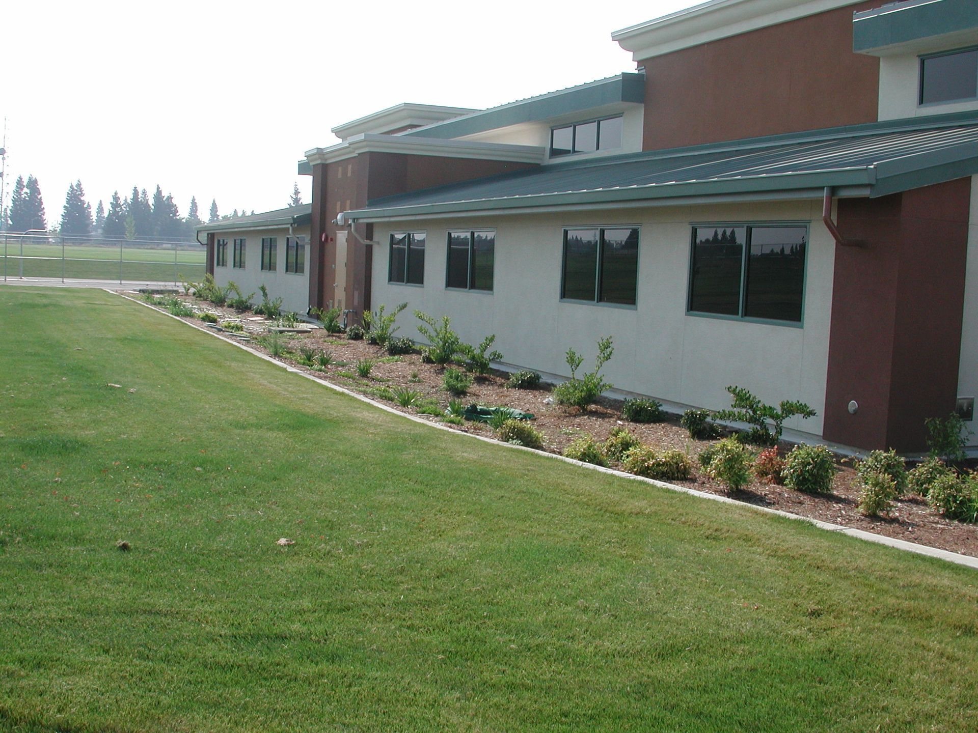 a building with a green roof and a lot of windows