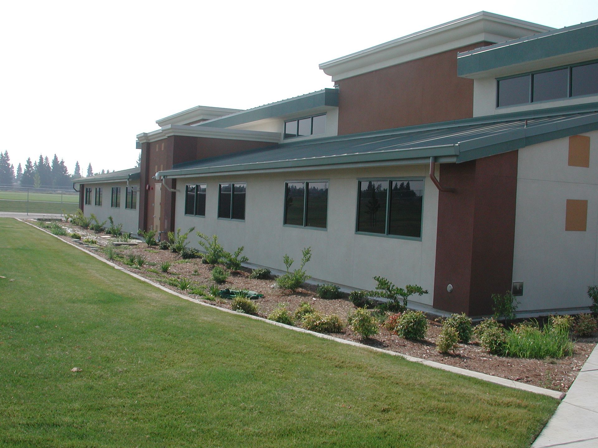 a large building with a green roof and a lot of windows